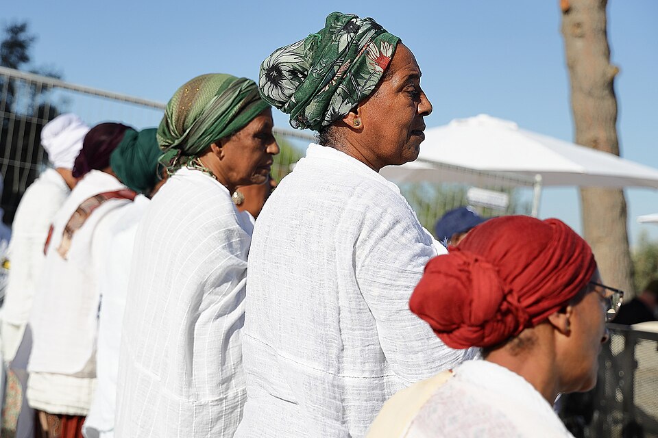 Ethiopian-Israeli women in white and colorful headwraps celebrating Sigd in Jerusalem