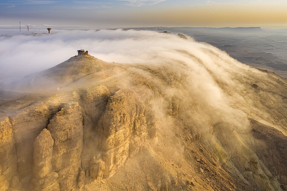 Clouds spilling over the rim of Makhtesh Ramon at sunrise